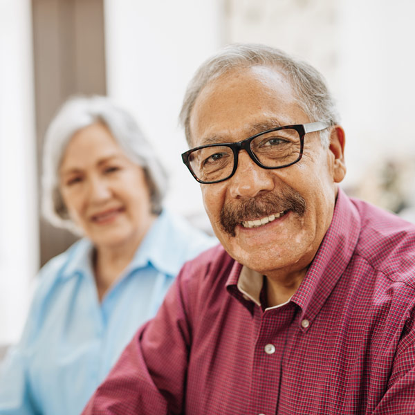 man with glasses and wife smiling