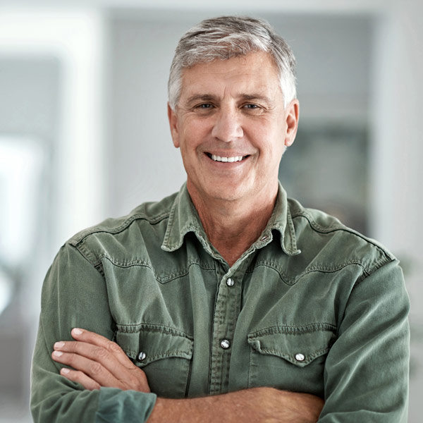 man in green shirt smiling